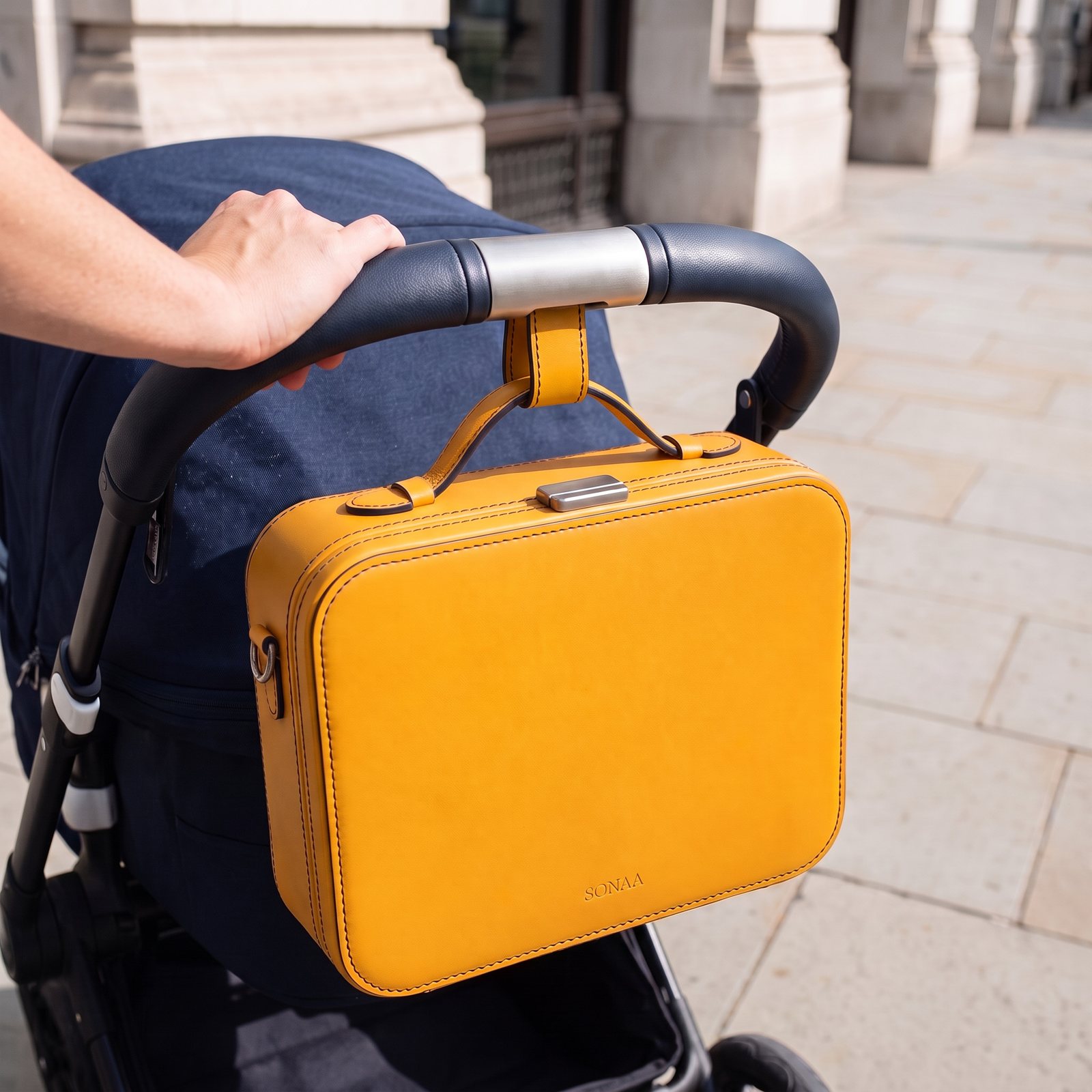 The Valise hanging level from a titanium dock on a stroller